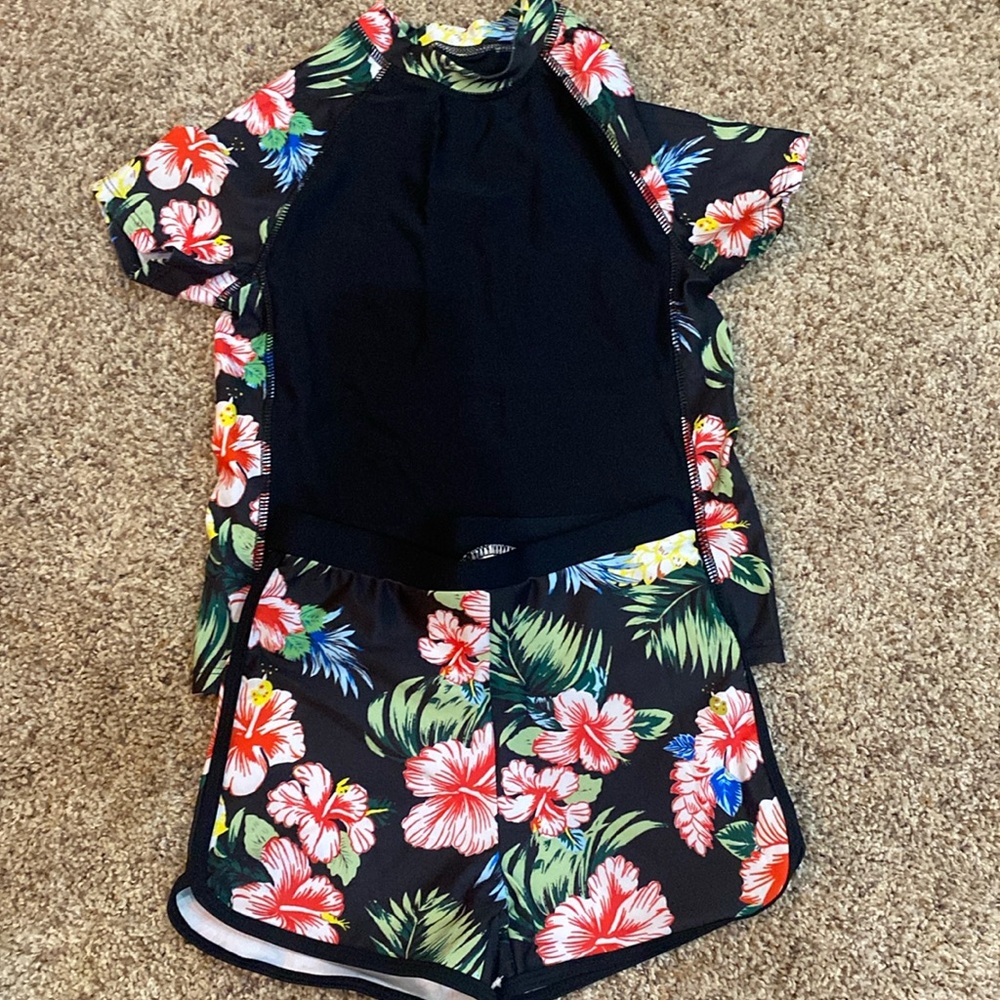 New 2 piece girls swim set 9T Hawaiian patterns.